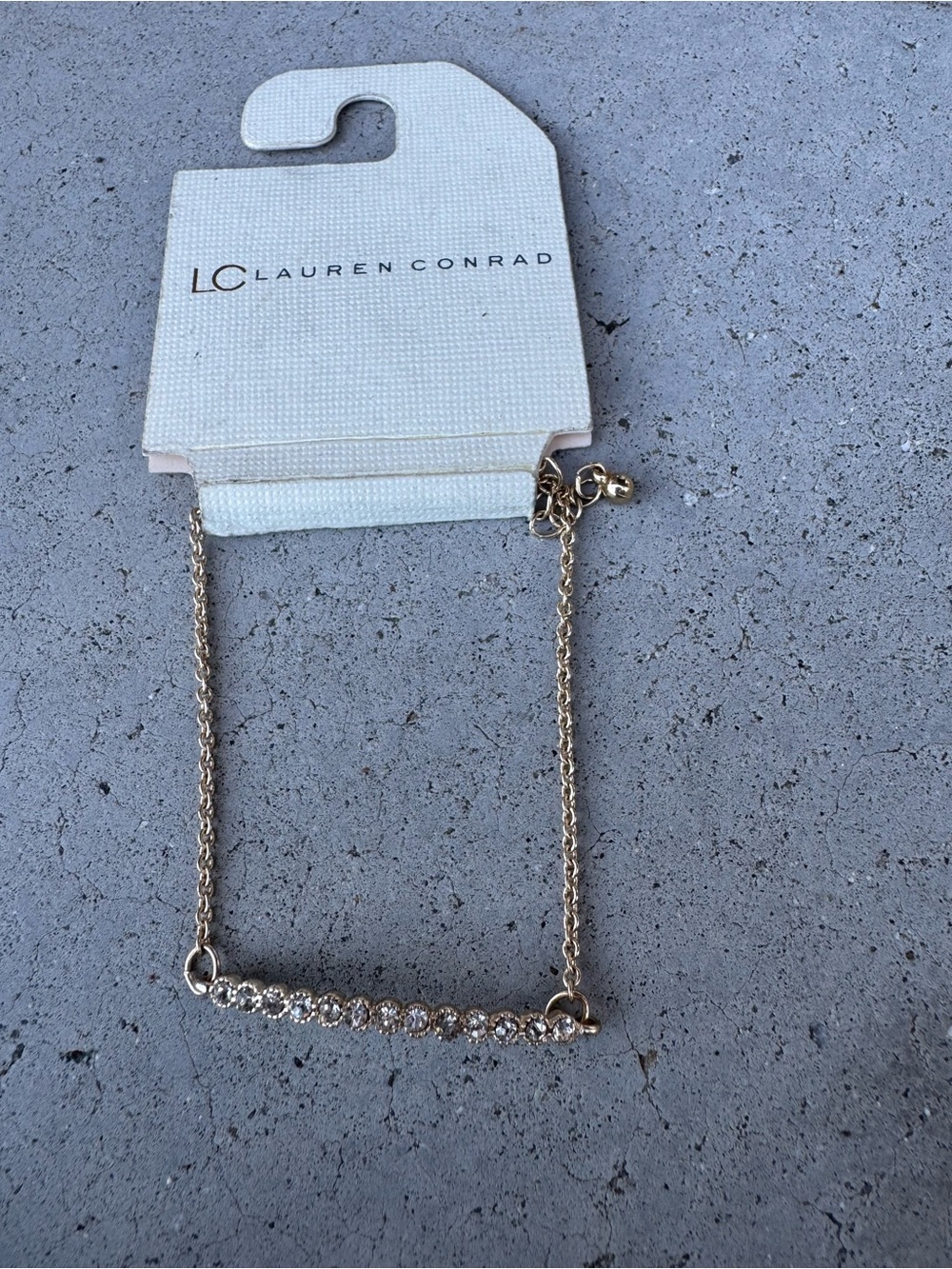 Lauren Conrad gold toned bracelet with rhinestone bar